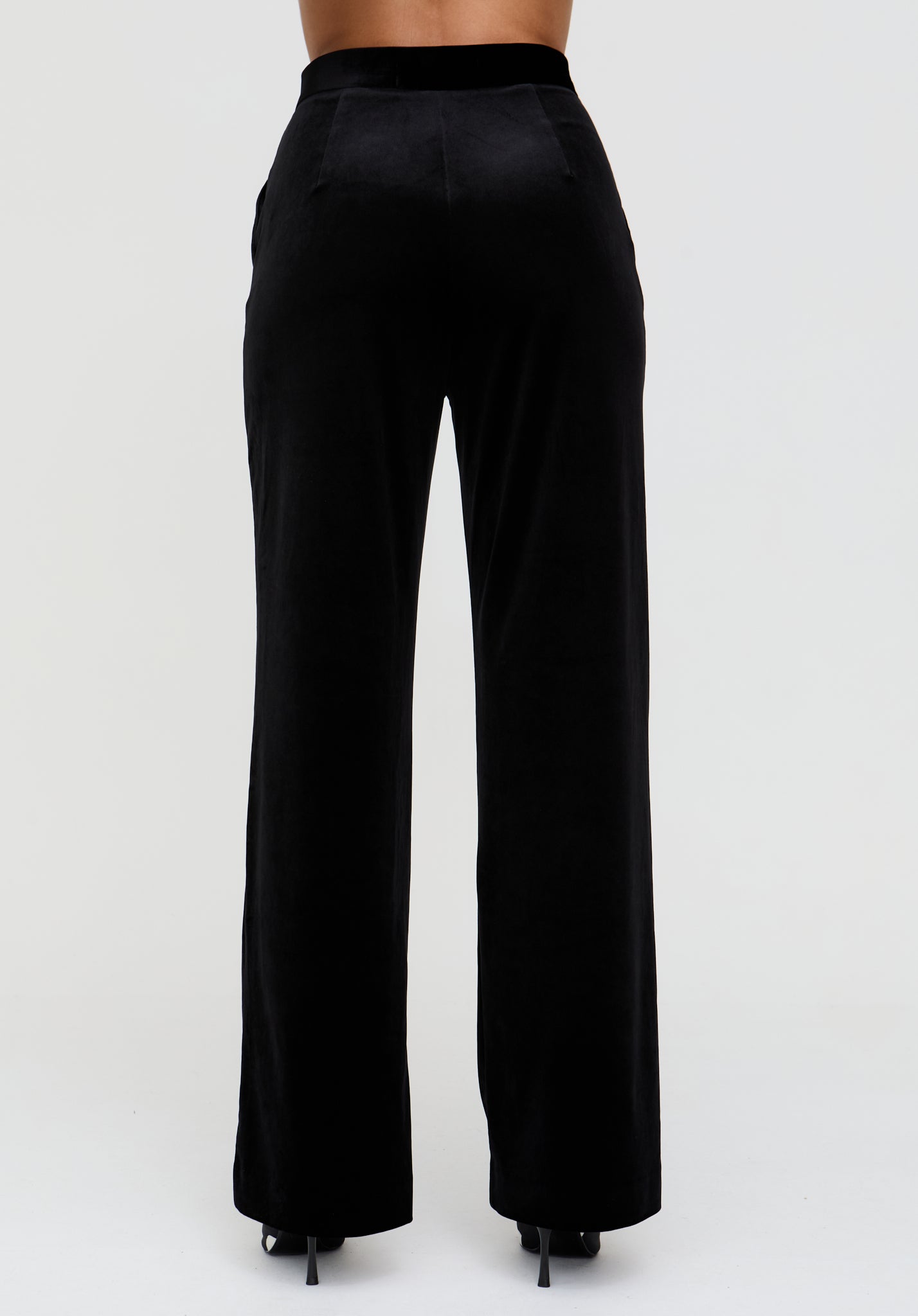 Black high-waisted pants on a white background