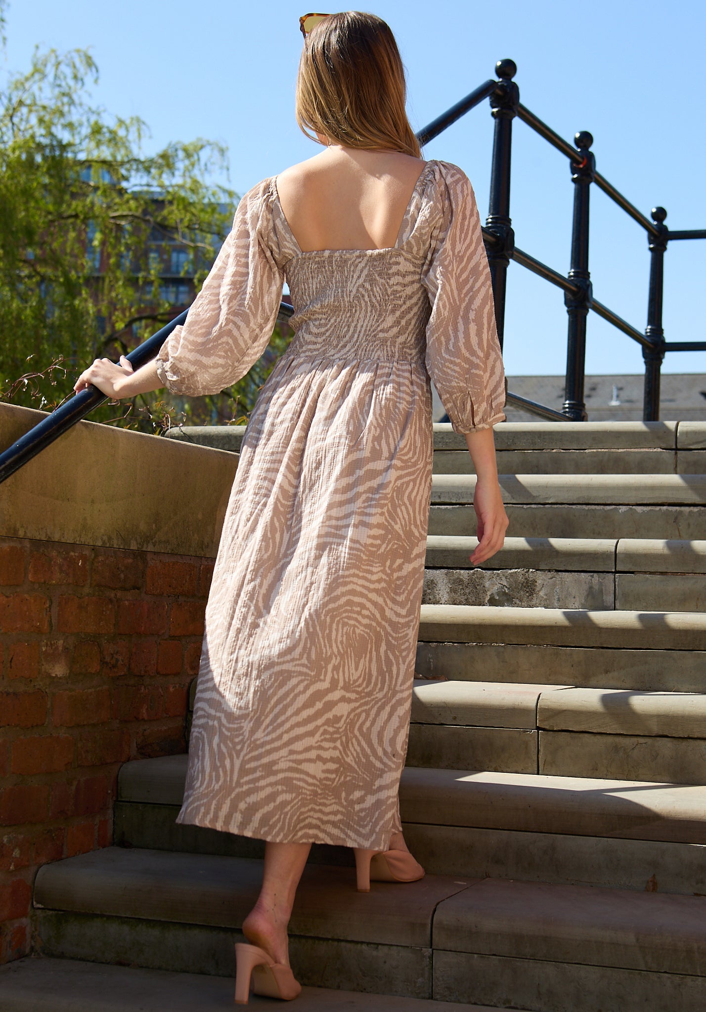 model wearing Lauren Shirred Bodice Banana Print Maxi Dress In Brown - image 5