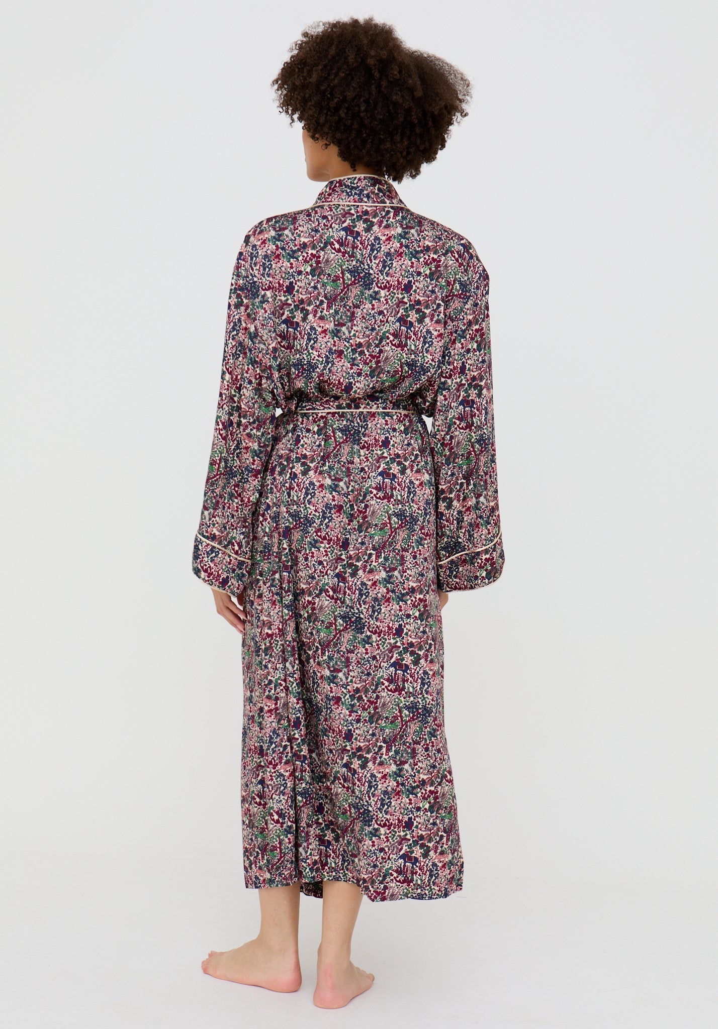 Person wearing a floral robe on a white background