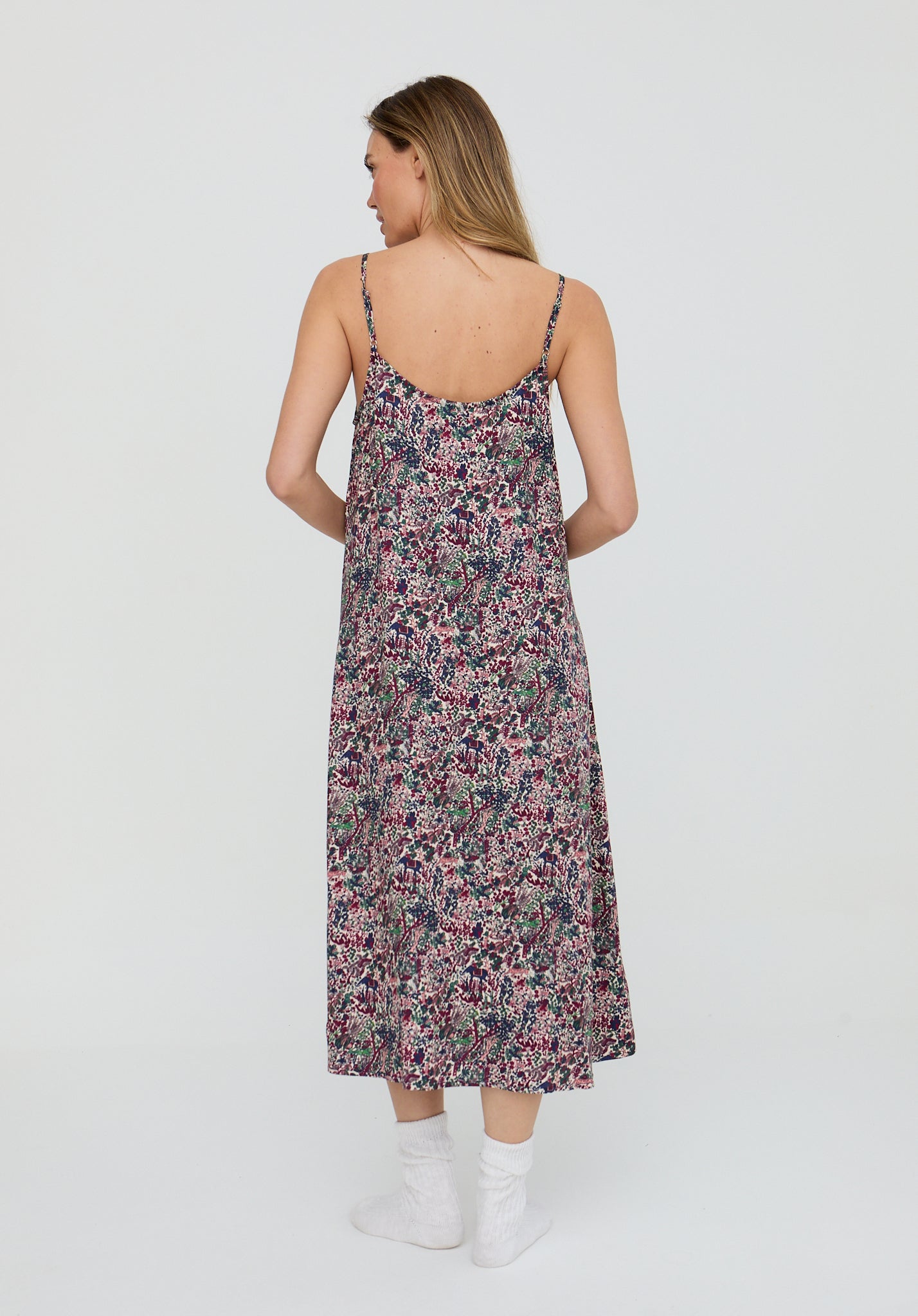 Woman wearing a floral dress on a white background