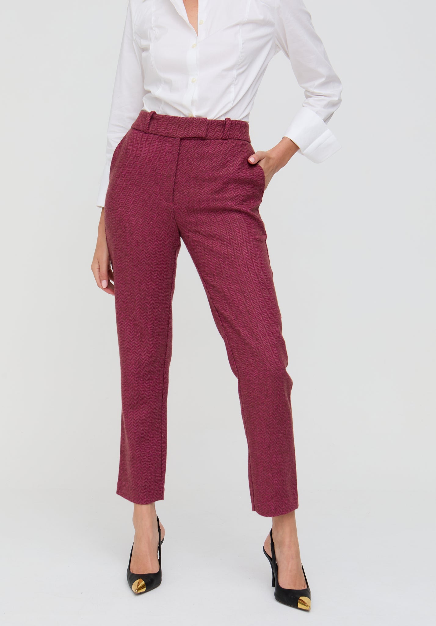 Person wearing maroon pants and a white shirt on a white background