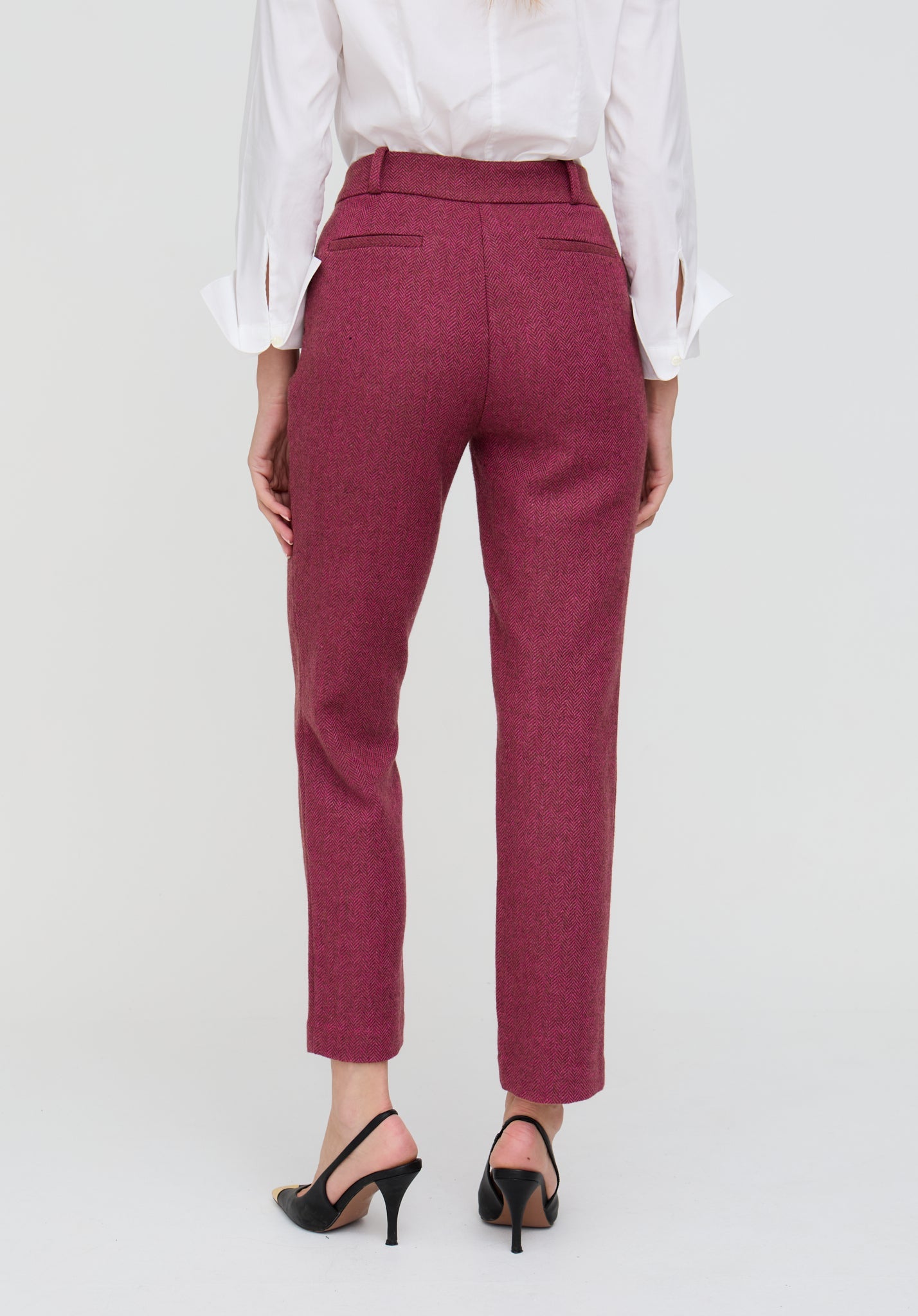 Maroon pants worn by a person on a white background