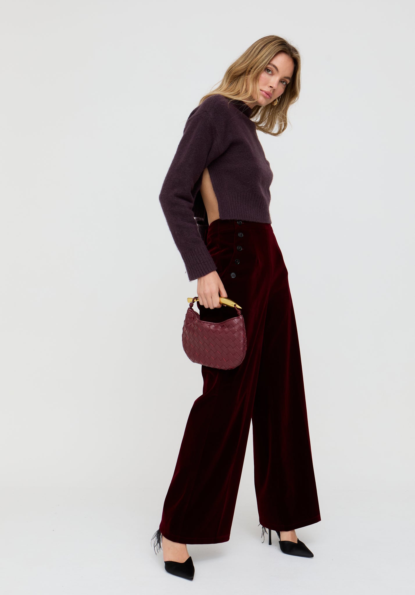 Woman holding a handbag against a white background