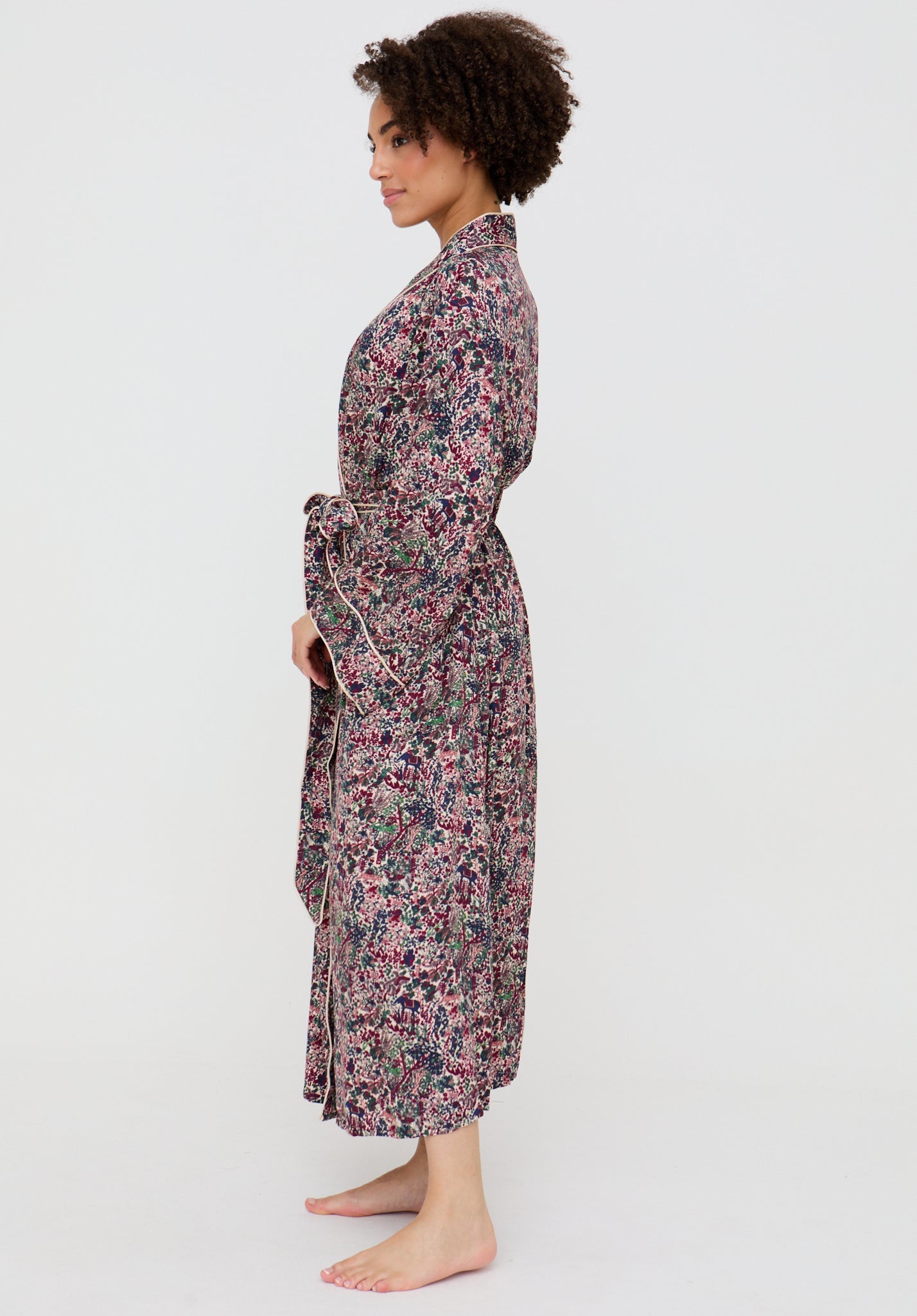 Woman wearing a floral patterned robe on a white background
