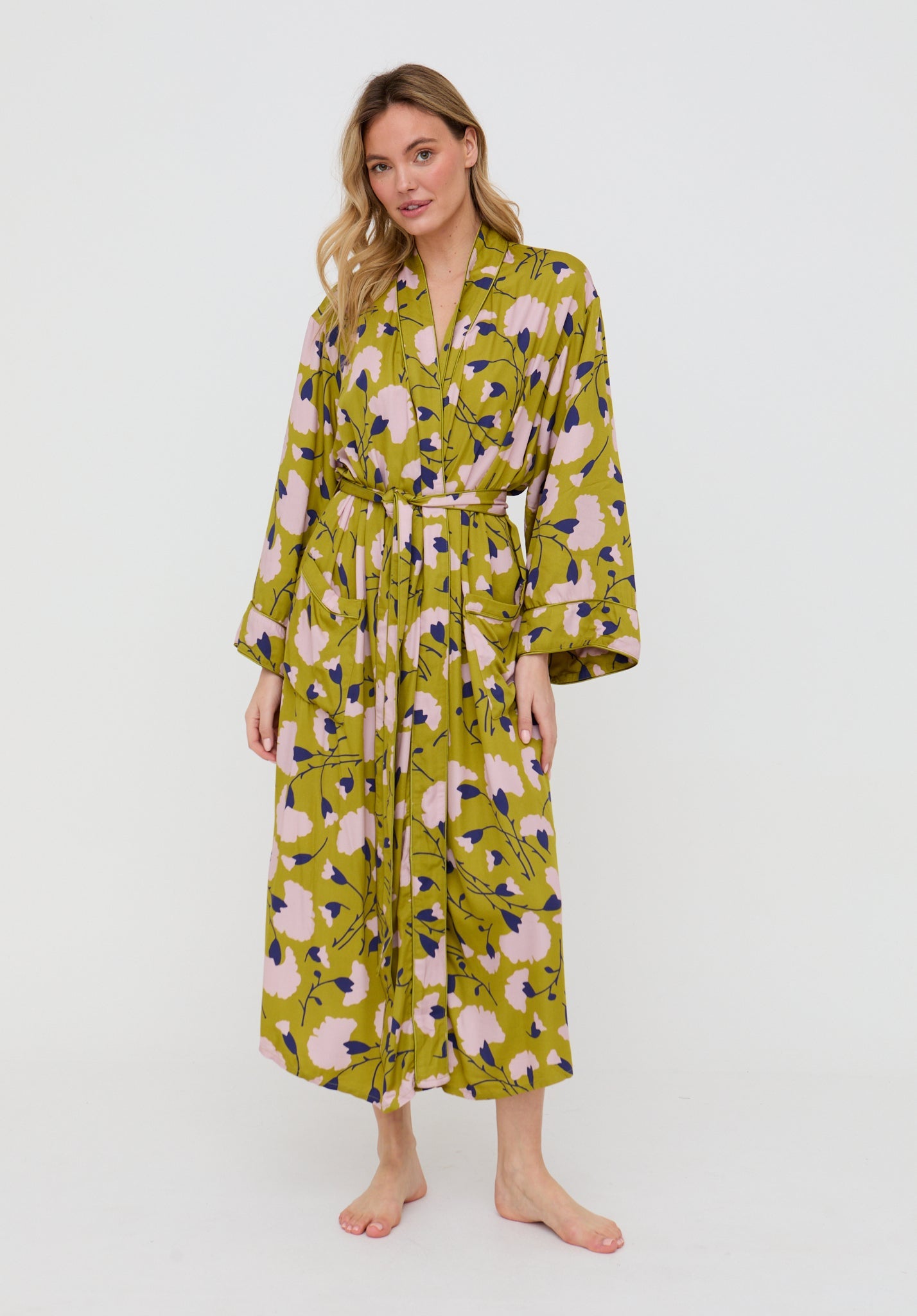 Woman wearing a floral patterned robe on a white background