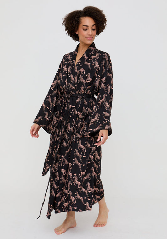 Woman wearing a black and brown patterned robe on a white background