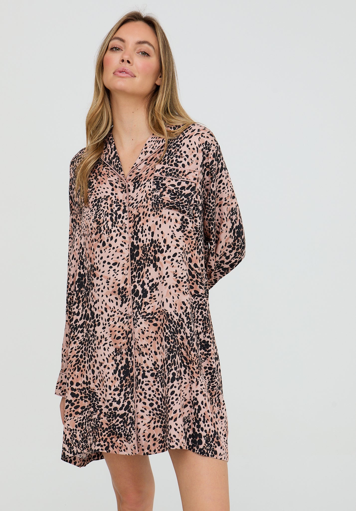 Woman wearing a leopard print dress on a white background