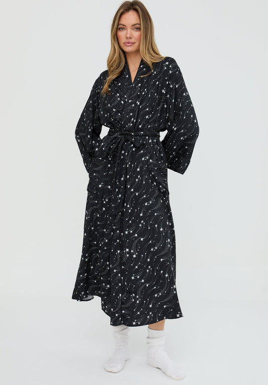 Woman wearing a black patterned dress on a white background