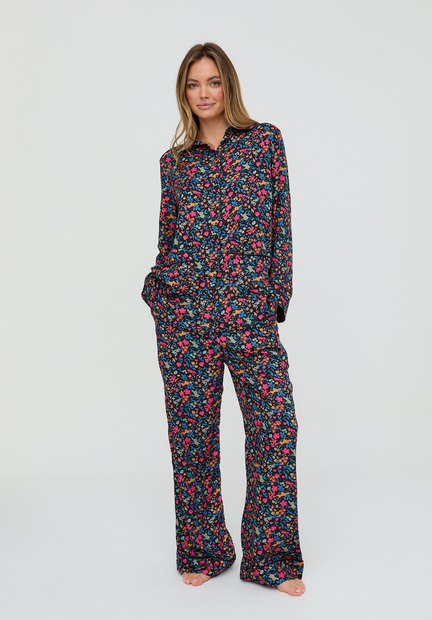 Woman wearing a floral pajama set on a white background