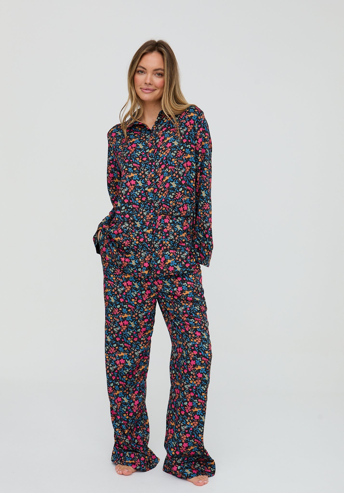 Woman wearing a floral pajama set on a white background