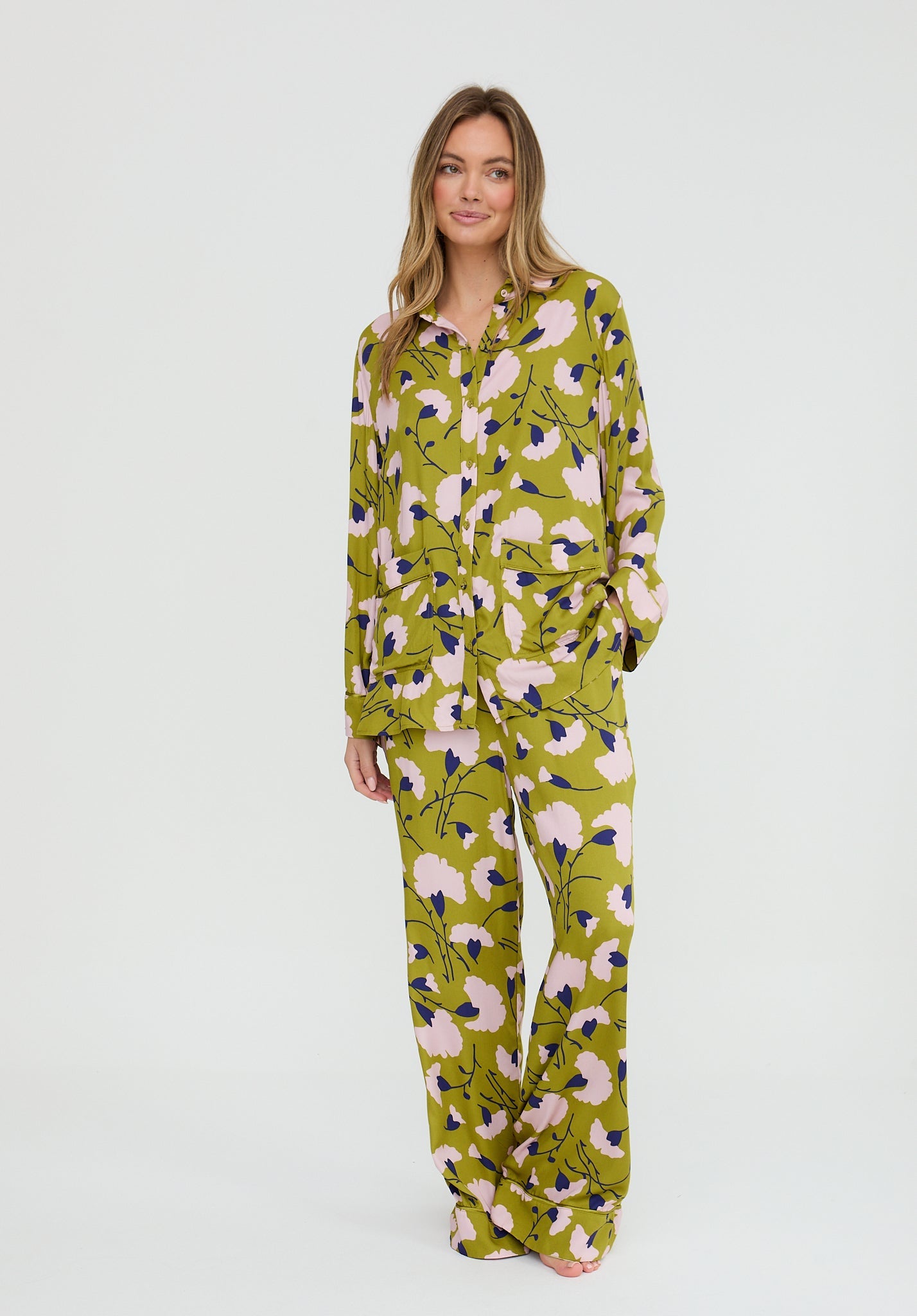 Woman wearing a floral patterned onesie on a white background
