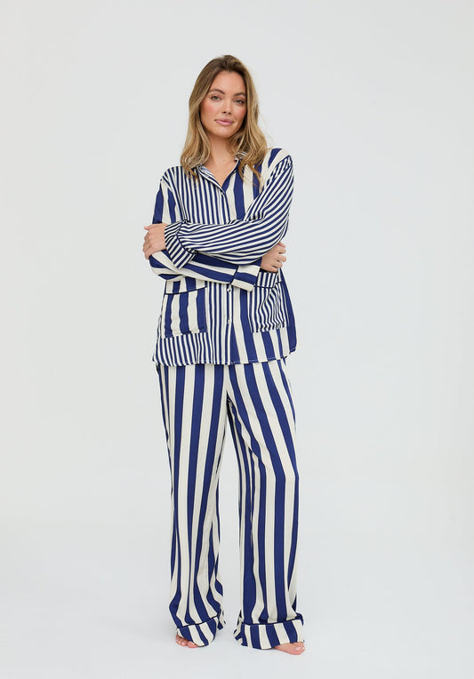 Woman wearing a blue and white striped outfit on a white background