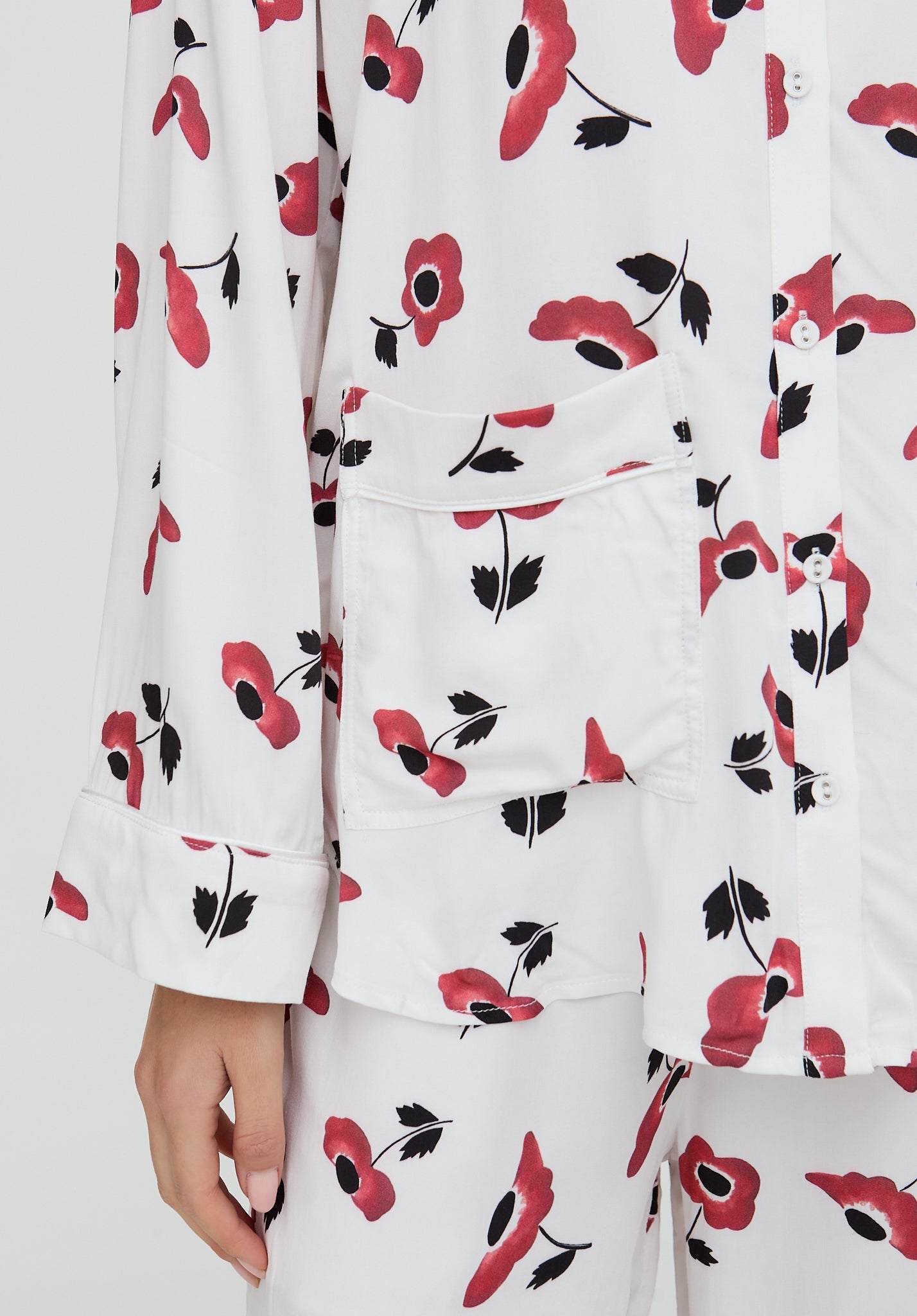 White outfit with red and black floral pattern on a white background