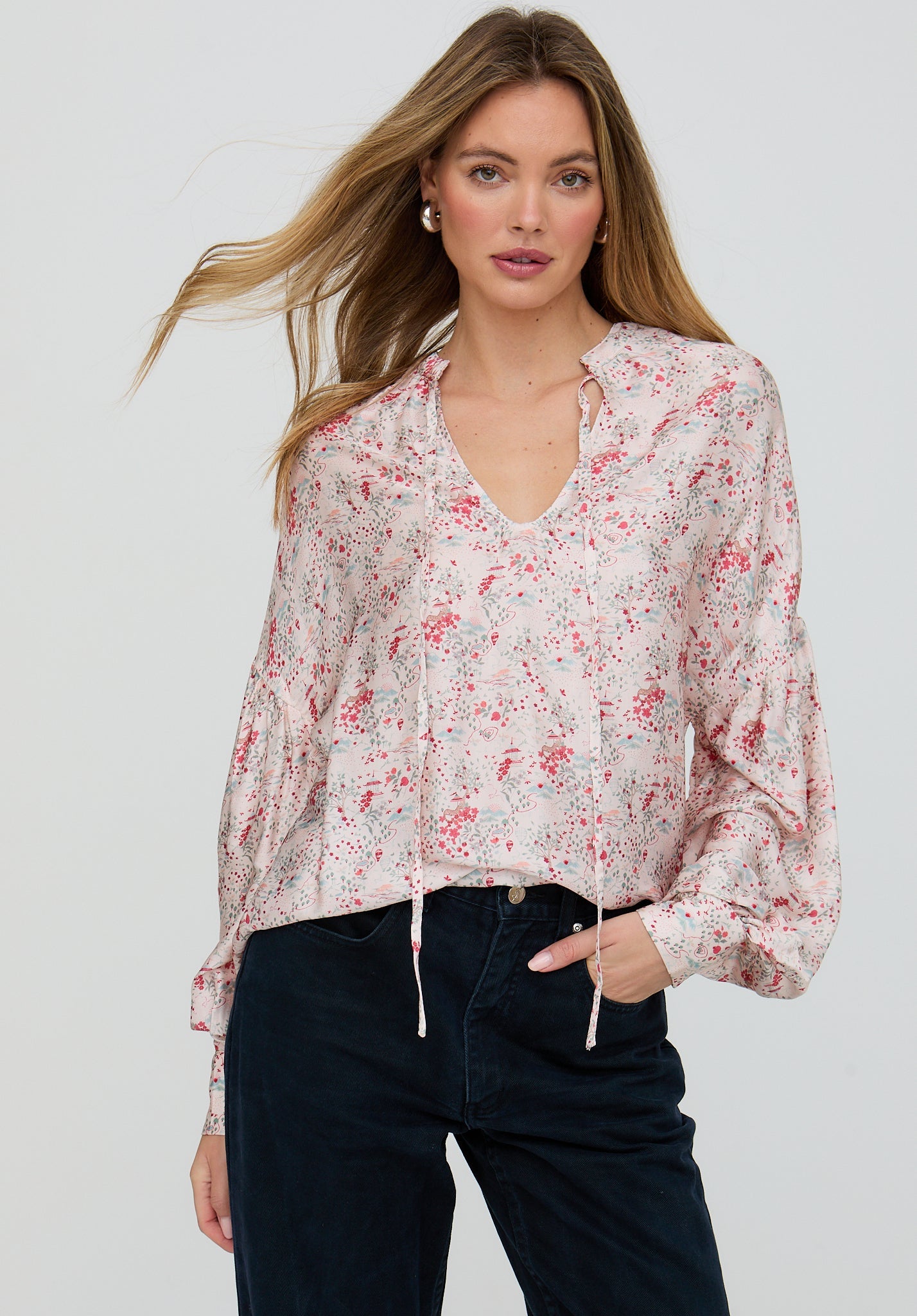 Woman wearing a floral blouse with a plain background