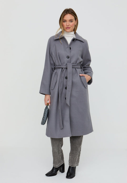 Woman wearing a gray coat on a white background