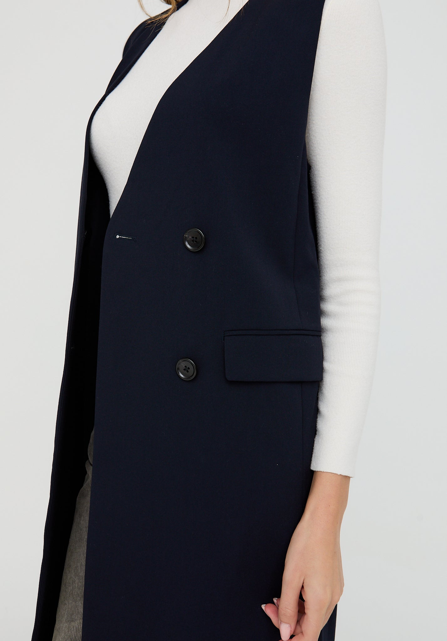Navy blue vest with buttons on a white background