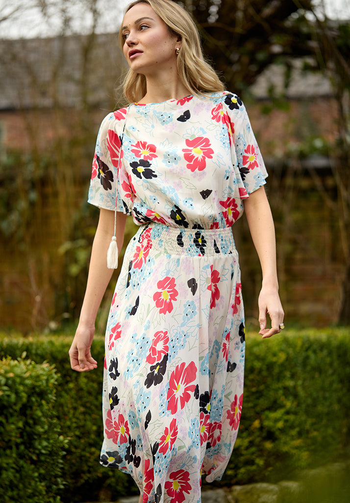 lifestyle image showing model wearing Galaxy Cowl Neck Poppy Print Midi Dress In Multi