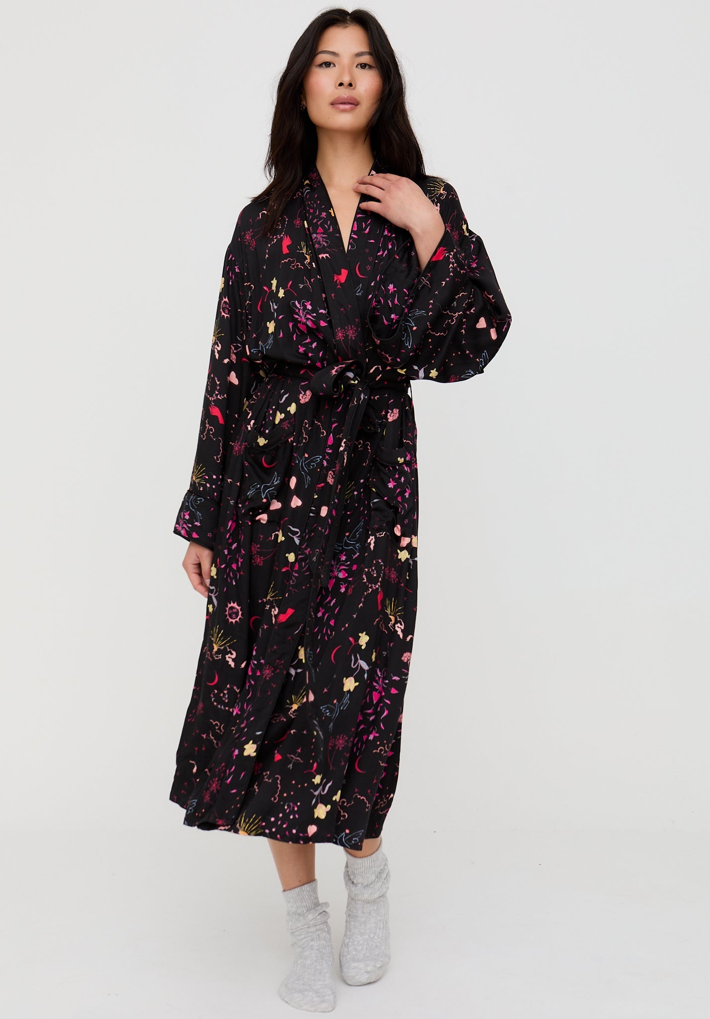 Woman wearing a black floral dress on a white background