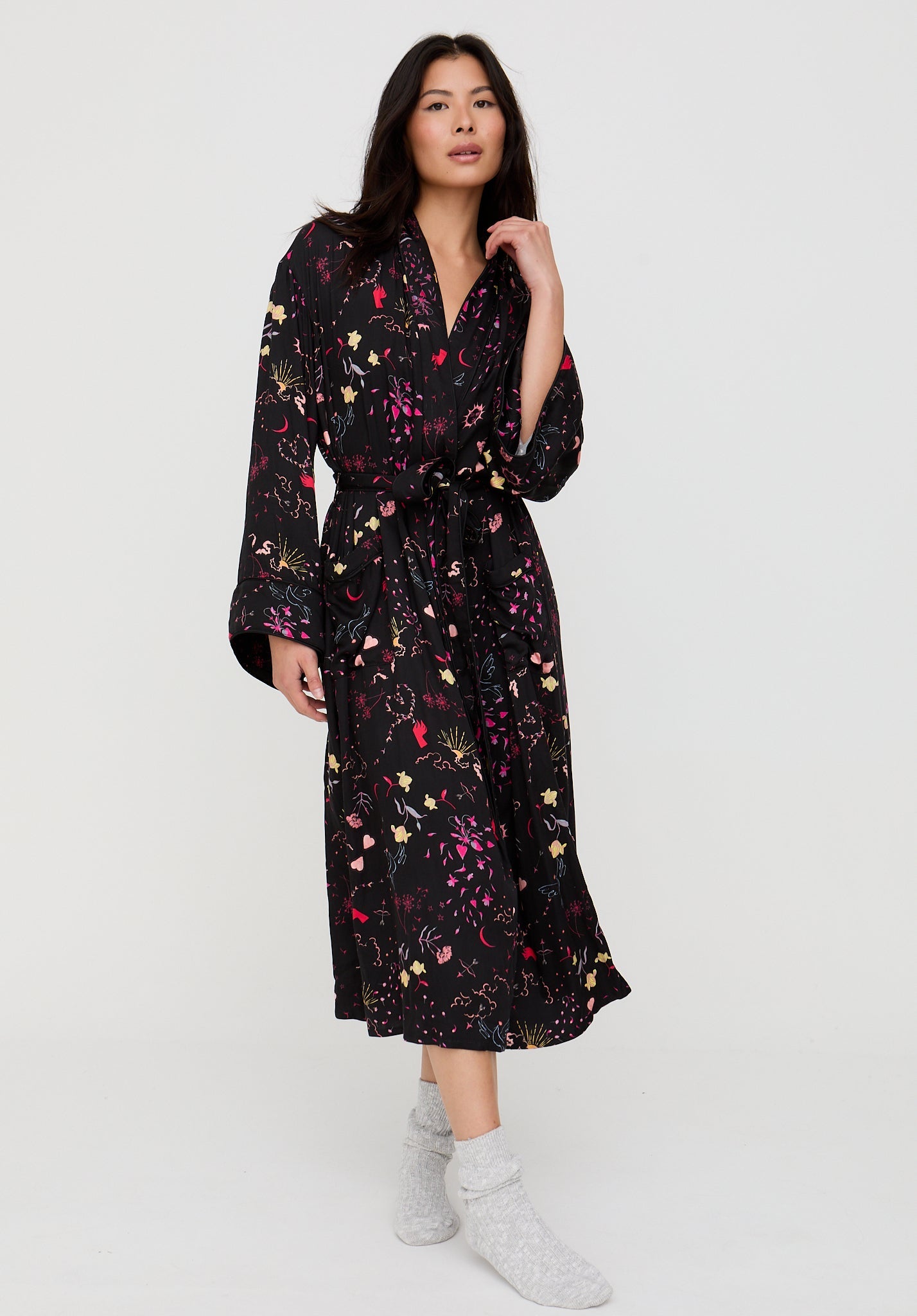 Woman wearing a black floral dress on a white background