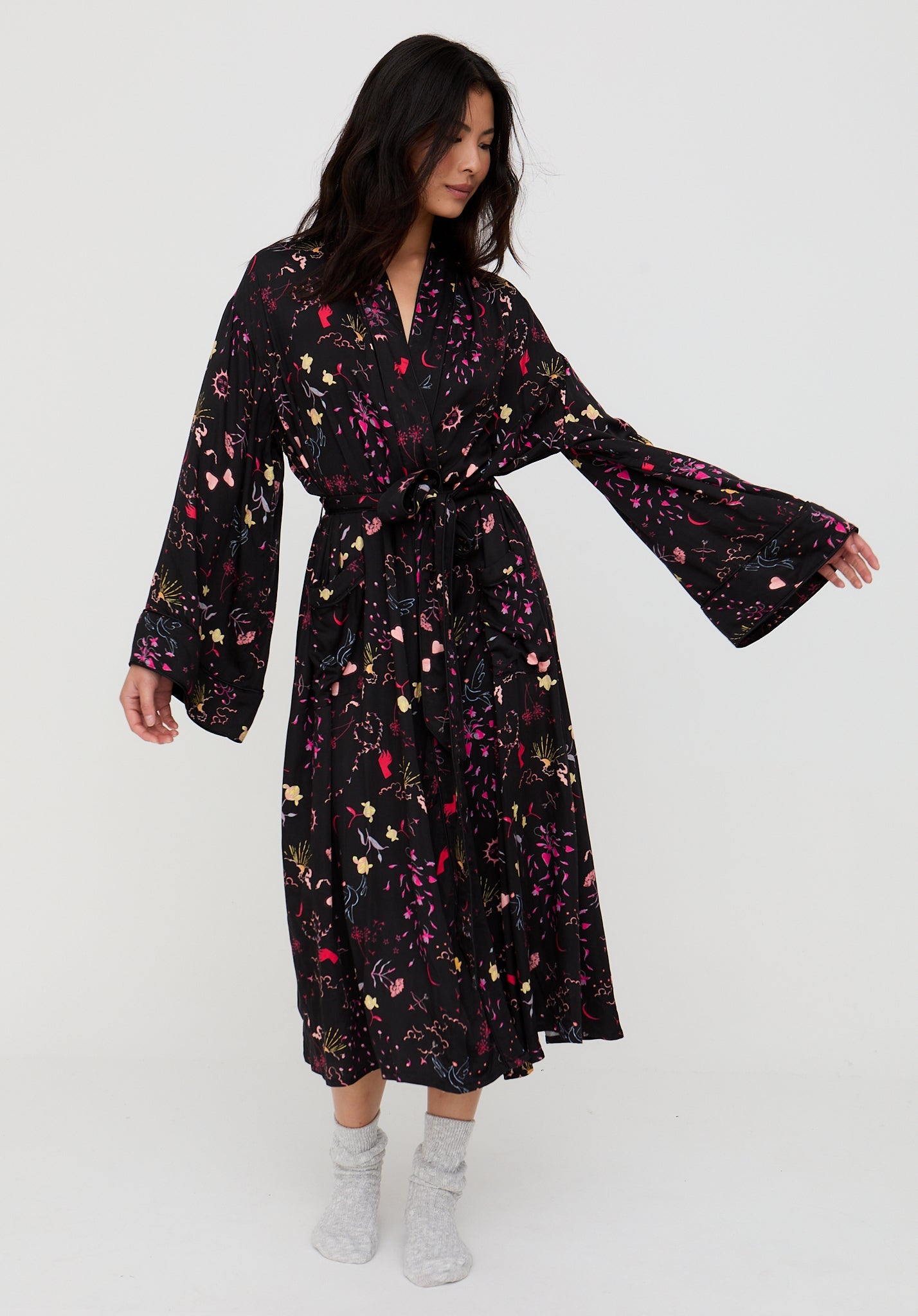 Woman wearing a black floral dress on a white background