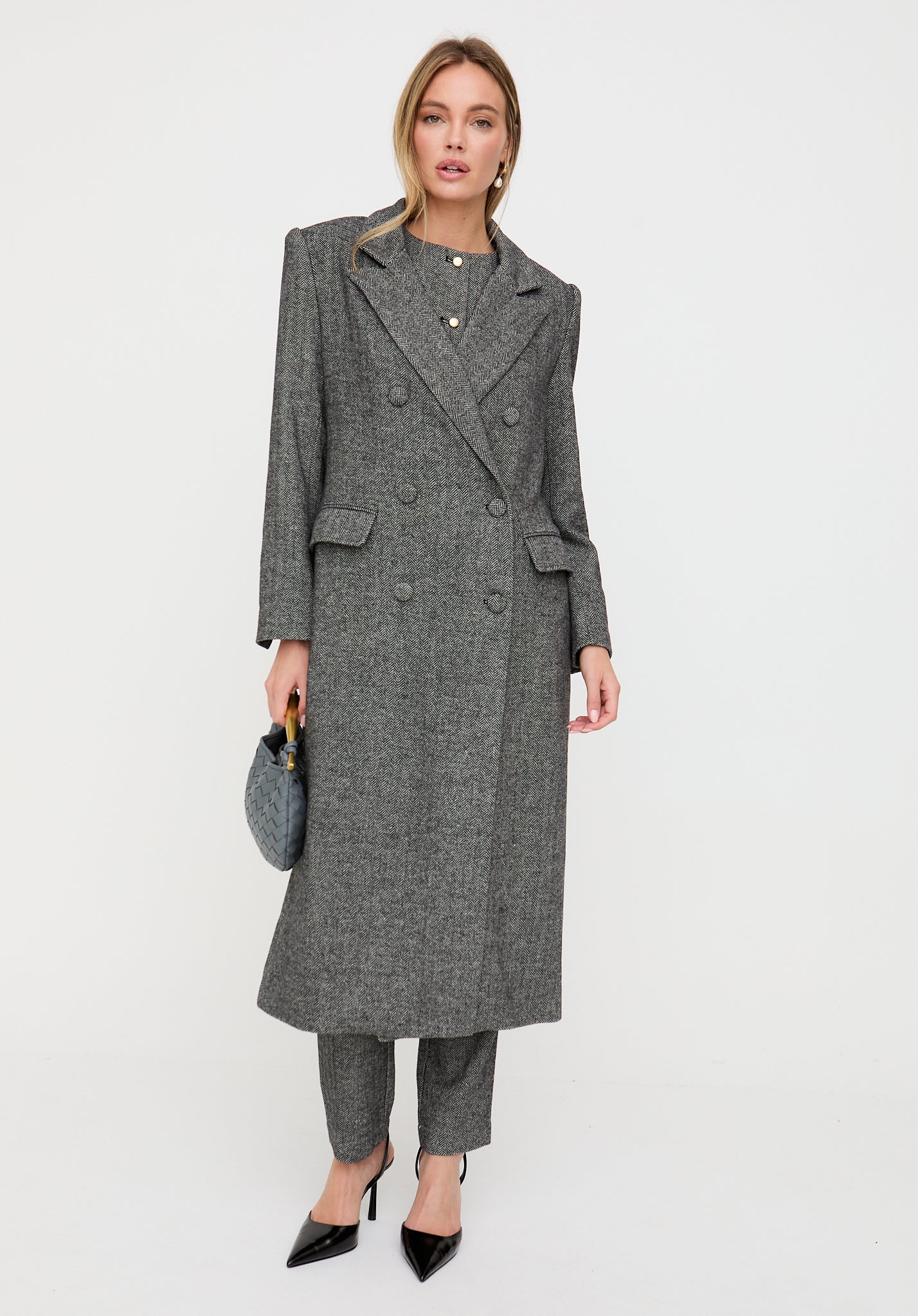 Woman wearing a gray coat on a white background