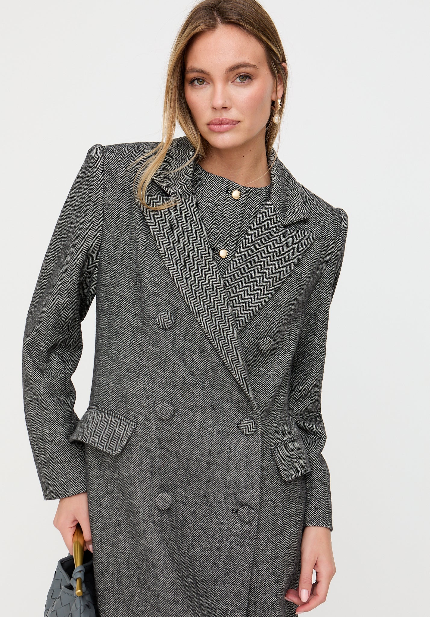 Woman wearing a gray coat on a white background