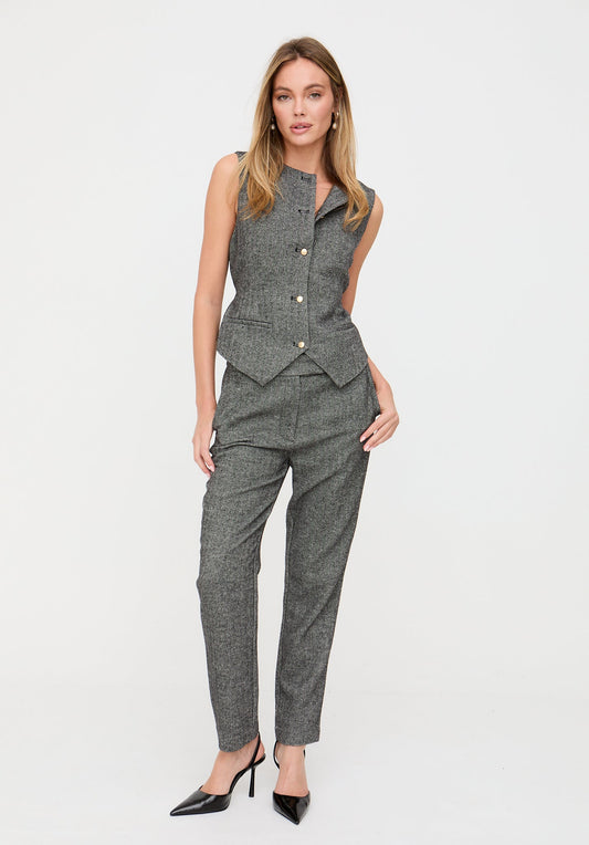 Woman wearing a gray suit on a white background