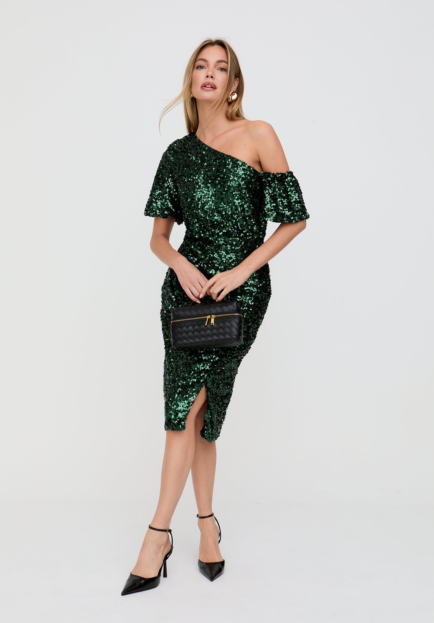 Woman wearing a green sequin dress on a white background