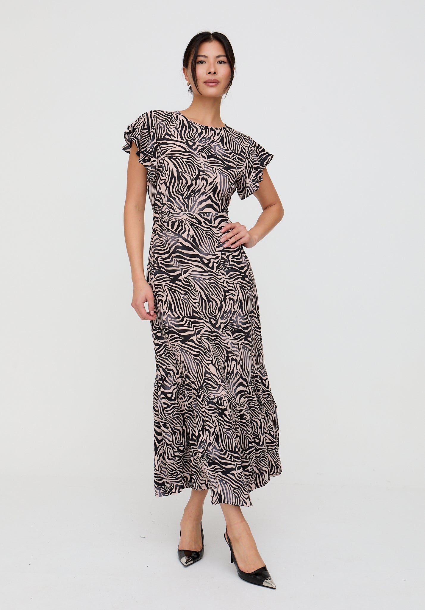 Woman wearing a zebra print dress on a white background