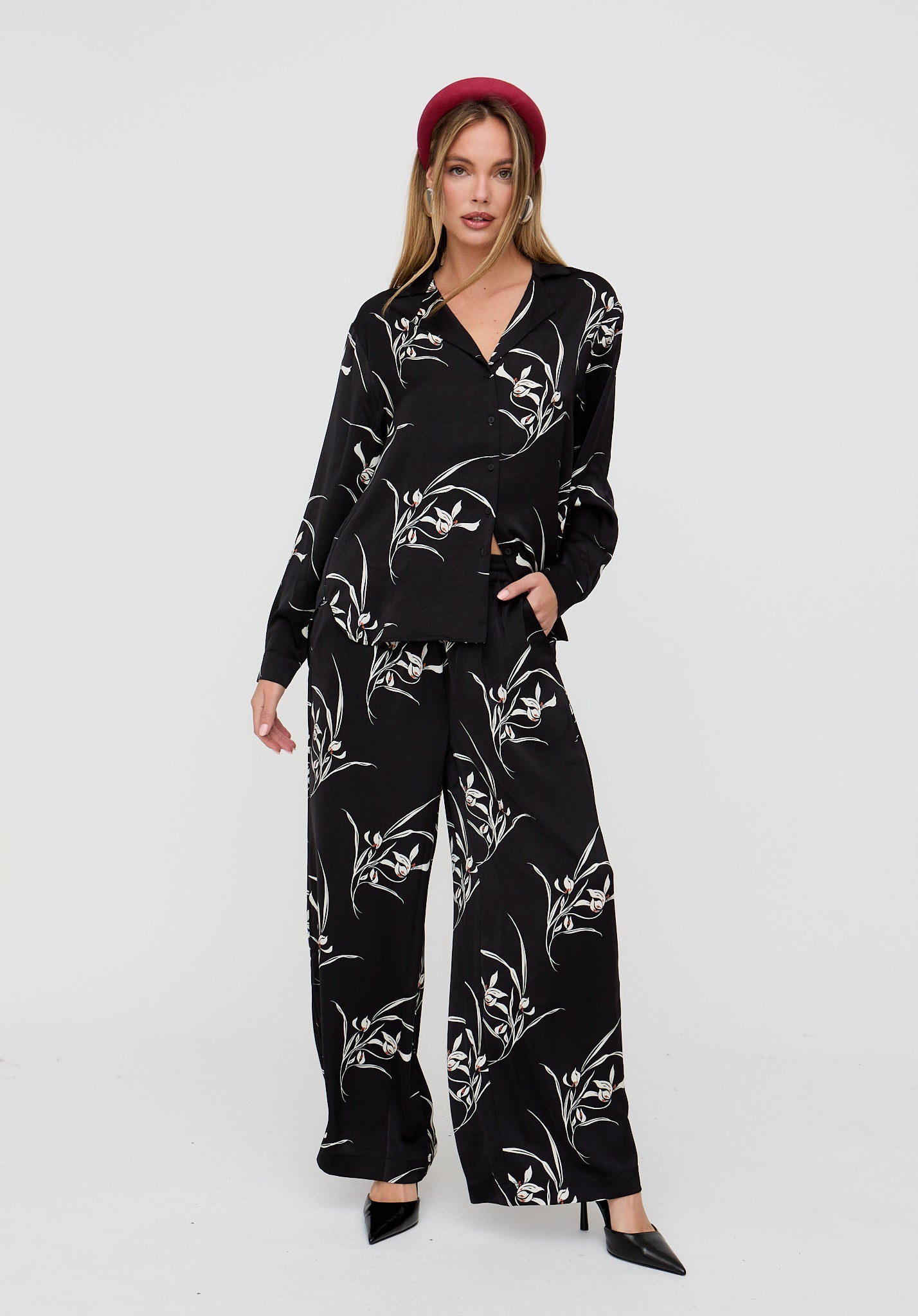 Woman wearing a black floral outfit on a white background