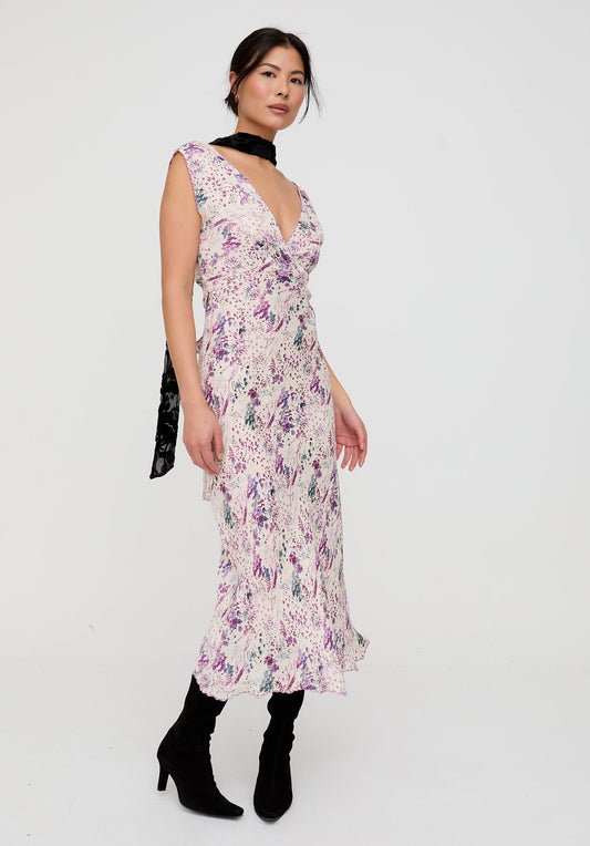 Woman wearing a floral dress with a plain background