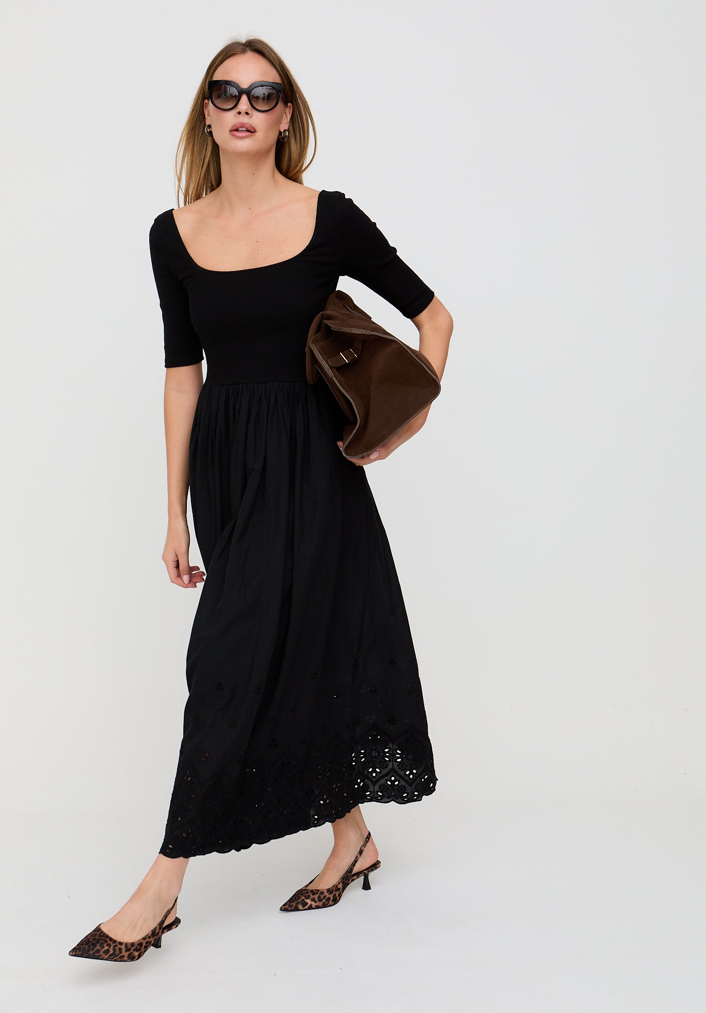 Woman wearing a black dress with a plain white background