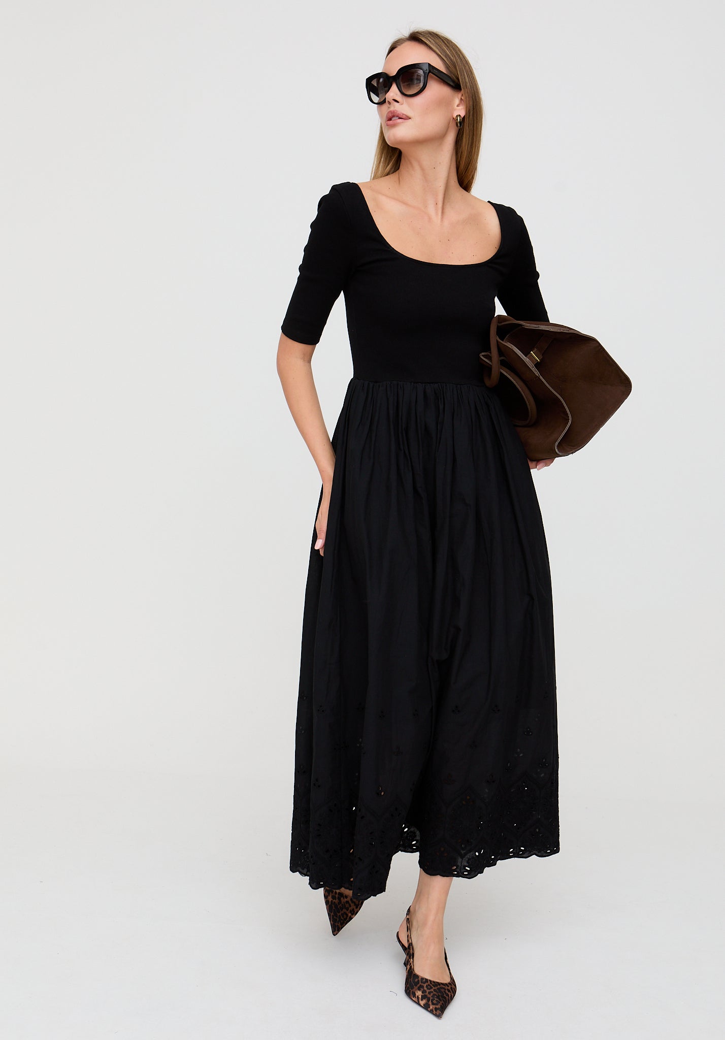 Woman wearing a black dress with a plain background