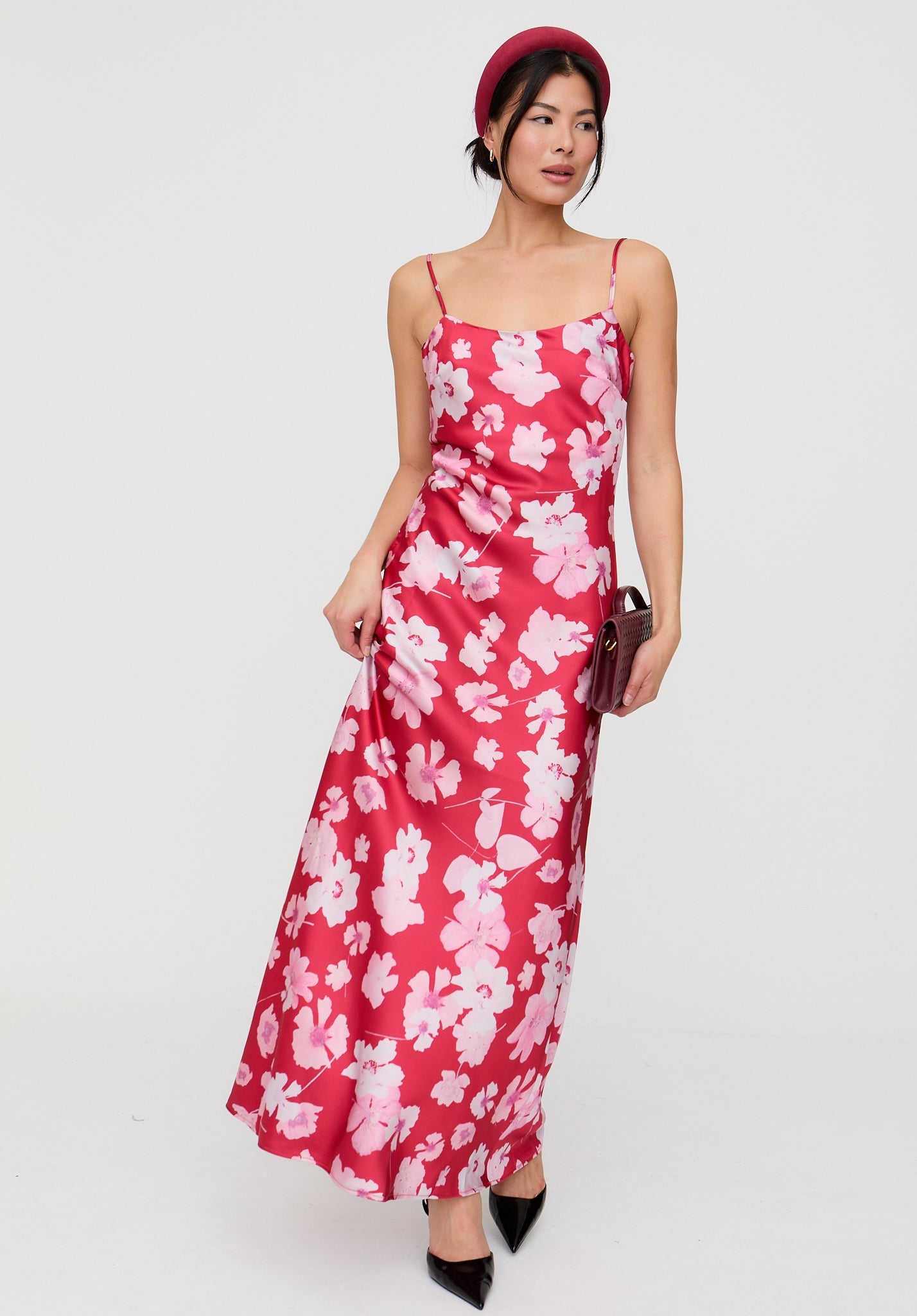 Woman wearing a red floral dress on a white background